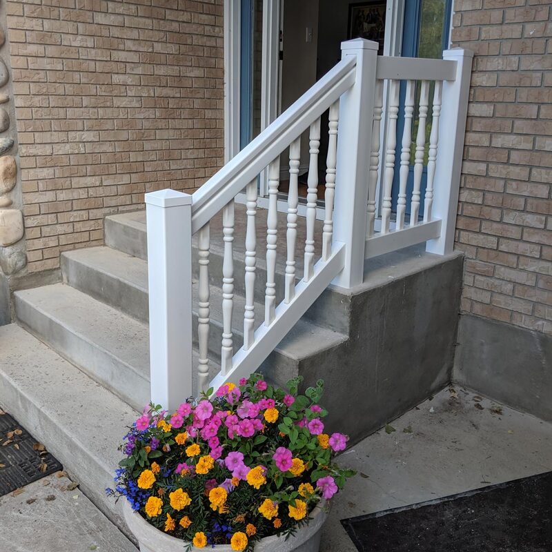 Transform your tired front entrance concrete steps into a stylish, low-maintenance feature with a custom railing installation from DeckPro LLC. This project involved the installation of a clean, bright white decorative vinyl railing system onto existing, unpainted concrete steps. The railing features traditional baluster-style decorative pickets and robust posts with decorative pyramid caps, providing classic curb appeal.