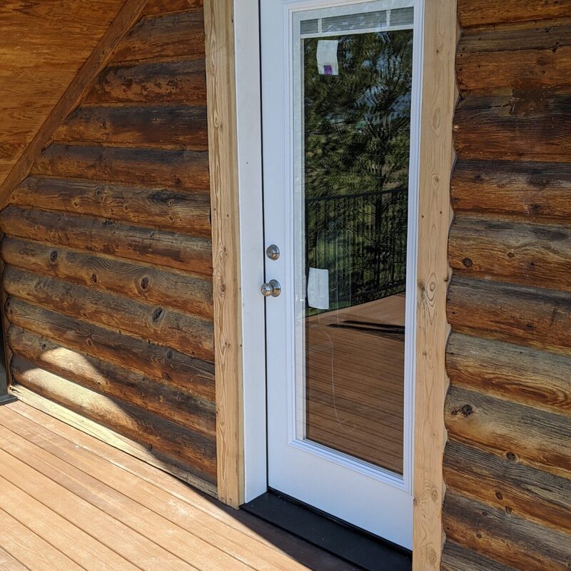 Expand your outdoor living possibilities with this custom deck by DeckPro LLC, which combines rustic elements with modern materials. We installed low-maintenance composite decking in a warm brown tone and paired it with a unique railing system that features natural wood posts and integrated wire mesh infill panels. For the ultimate in functional design, we included extensive built-in L-shaped bench seating, creating a cozy and inviting perimeter perfect for taking in scenic views.