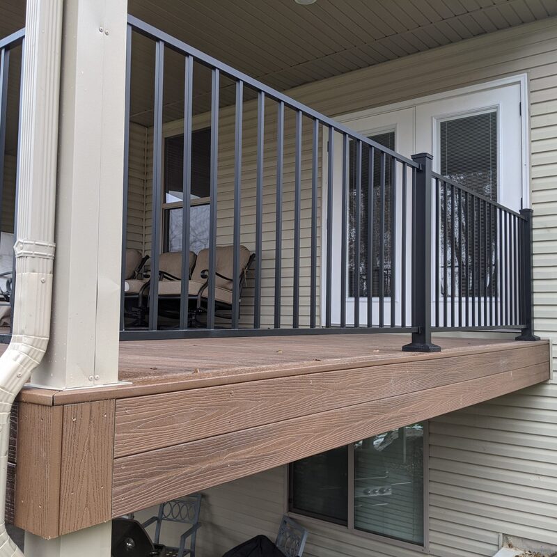 Upgrade your home's exterior with a stunning, low-maintenance composite deck. This custom project by DeckPro LLC pairs durable wood-tone composite decking with modern black metal railing for a clean, sophisticated look built to withstand Idaho weather.