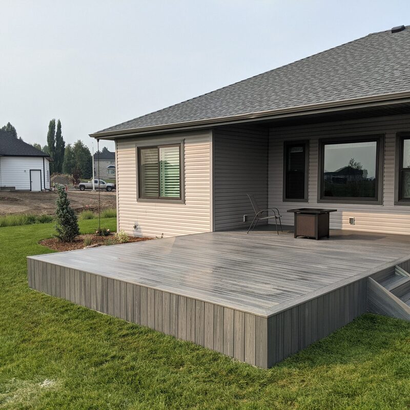 Expand your outdoor living space with this custom deck project by DeckPro LLC, designed to blend rustic charm with modern durability. This build features low-maintenance composite decking and a unique perimeter railing that combines natural wood posts with wire mesh infill panels. The functional design includes extensive built-in bench seating, making it an inviting retreat perfect for relaxing and taking in scenic, natural views.