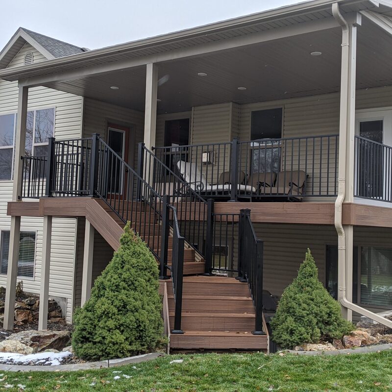 Expand your outdoor living space with this custom deck project by DeckPro LLC, designed to blend rustic charm with modern durability. This build features low-maintenance composite decking and a unique perimeter railing that combines natural wood posts with wire mesh infill panels. The functional design includes extensive built-in bench seating, making it an inviting retreat perfect for relaxing and taking in scenic, natural views.