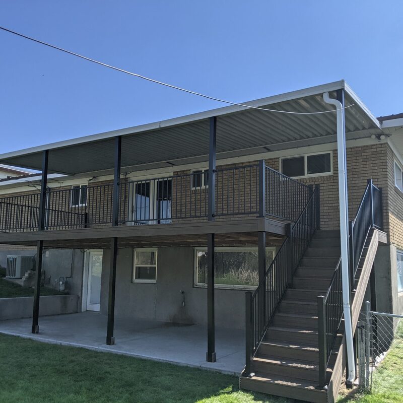 Maximize your outdoor living with a custom second-story deck from DeckPro LLC. This project features durable composite decking, sleek metal railing, and a full roof cover that provides a dry, shaded patio space underneath.