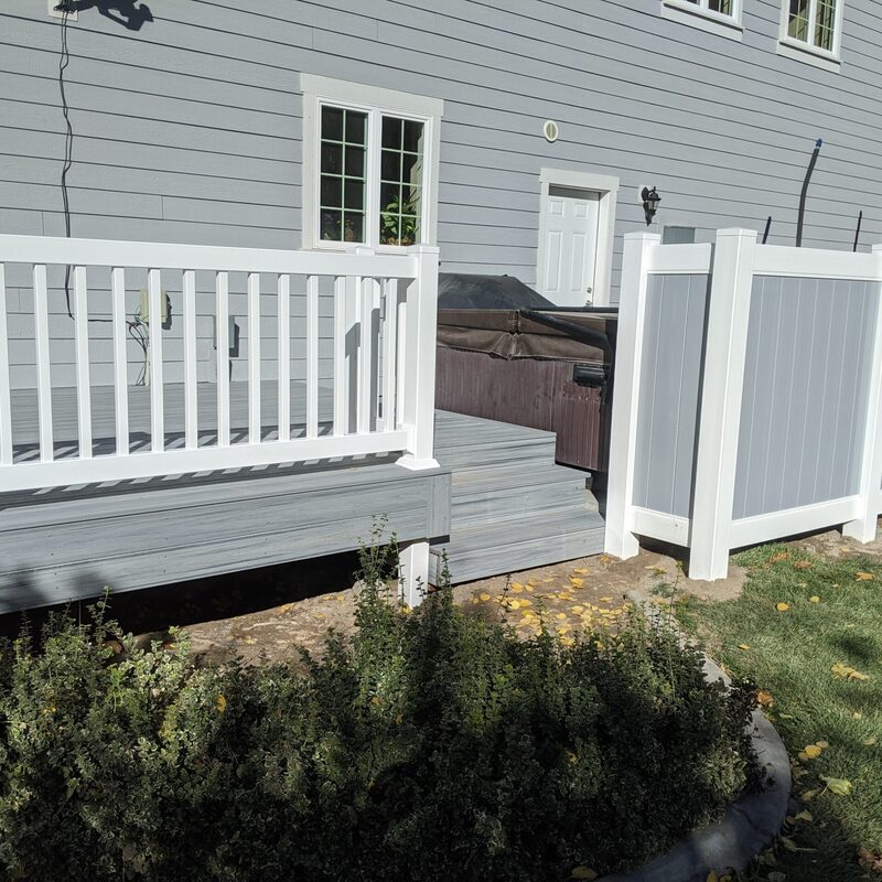 Enhance your backyard retreat with DeckPro LLC’s signature Integrated Spa Deck and White Vinyl Privacy Fence System. This comprehensive project seamlessly blends form and function, creating a sophisticated, low-maintenance outdoor living space. Featuring premium light-grey composite decking boards and a robust white vinyl railing system with vertical balusters and post caps, this raised platform offers years of worry-free relaxation.
