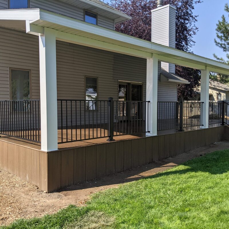 Elevate your outdoor living with DeckPro LLC’s signature Wide-Span Attached Covered Composite Deck & Stair System. This comprehensive project transforms your backyard into a sophisticated, low-maintenance retreat. Featuring premium brown composite decking boards with a warm wood-grain texture and robust black metal railings, this spacious platform offers years of maintenance-free relaxation.