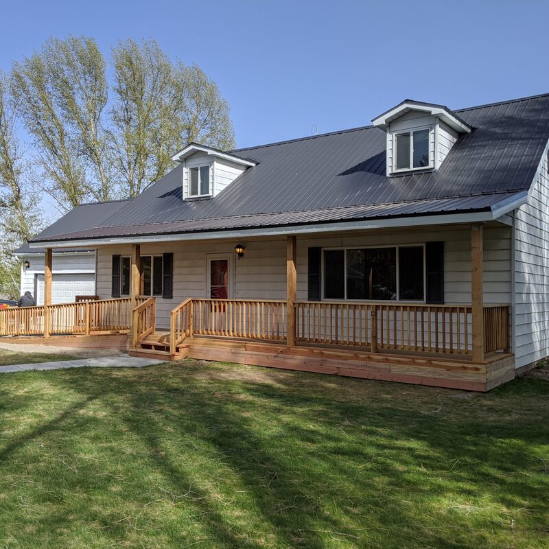 Transform your home's front entry and elevate its curb appeal with The Cedar Wraparound Front Porch Project with Picket Railing, a signature custom installation by DeckPro LLC. This expansive residential construction project creates a massive, low-profile outdoor living space that seamlessly wraps around the entire front and side facade of the home. Crafted with premium, natural cedar for the decking, clean picket railings, and robust support columns, this front entry deck offers the durable all-weather use of high-end low-maintenance materials.