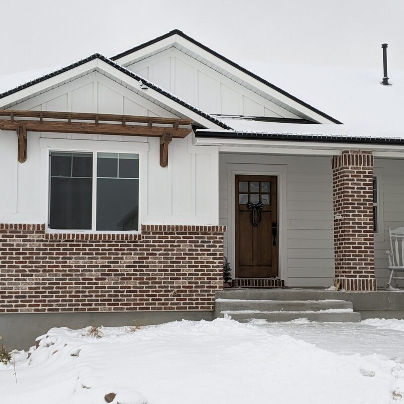 Expand your outdoor living space with this sophisticated custom deck by DeckPro LLC, pictured on a beautiful sunny day. We installed high-quality, low-maintenance composite decking planks in a clean wood-grain pattern, featuring contrasting dark perimeter railings for safety and sophisticated style. This sturdy retreat transitions seamlessly to a unique stamped concrete patio through a massive, inviting set of wide stairs. Perfect for relaxation or large-scale entertaining, this functional build optimizes views of the vast backyard. Direct access via a sliding glass door makes indoor-outdoor living effortless.
