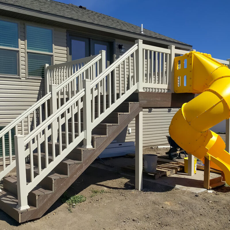Make your backyard the ultimate family destination! This custom project by DeckPro LLC includes a durable composite deck, safe white vinyl railing, and a fun spiral slide for endless summer fun.