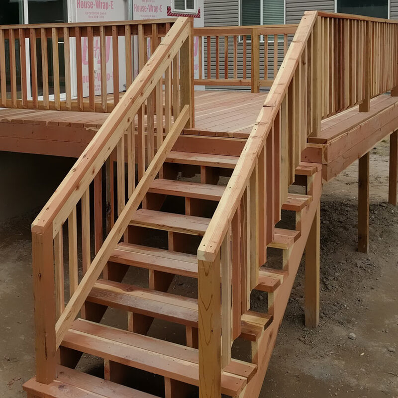 Enhance your home's exterior with the timeless appeal of a custom natural wood deck by DeckPro LLC. This recently completed raised deck project features sturdy construction, classic wood railings, and convenient stairs connecting the living space to the backyard, perfect for enjoying the outdoors.