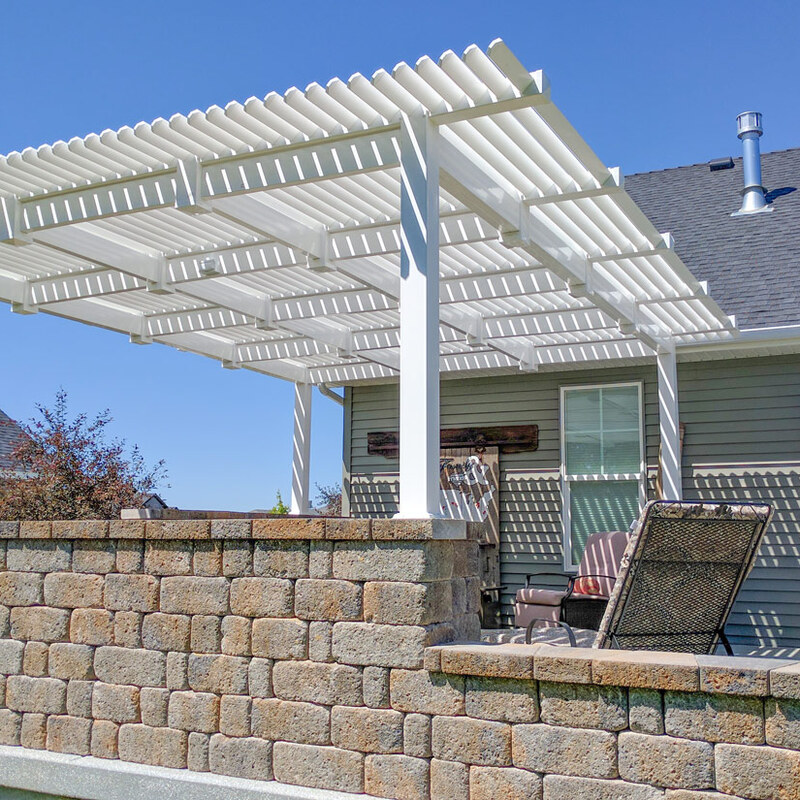 Extend your multi-level outdoor living with this sophisticated composite deck project by DeckPro LLC. This functional retreat features massive connecting stairs leading down to a beautifully integrated landscape with various bushes and large natural boulder rocks on a gravel bed. Perfect for relaxation or large-scale entertaining, this sturdy retreat transitions smoothly from defined sun and shade zones, utilizing expansive space under a covered pergola and optimizing multi-directional natural views. We installed high-quality composite decking planks in a clean pattern and paired them with safe and sophisticated dark vertical perimeter railings for defined zones that maximize multi-directional views. Pictured on a beautiful partly cloudy day, this backyard transformation creates a tranquil sanctuary perfect for large properties. Recessed lighting allows for extended evening use.